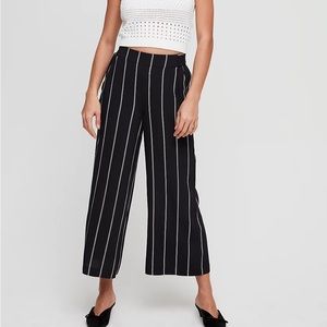 Black pants with white and red pinstripes. Wilfred brand from Aritzia